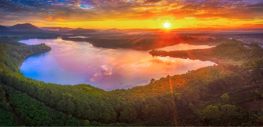 As dusk descends, Bien Ho Pleiku is draped in a romantic cloak, ablaze with hues of orange, pink, an...