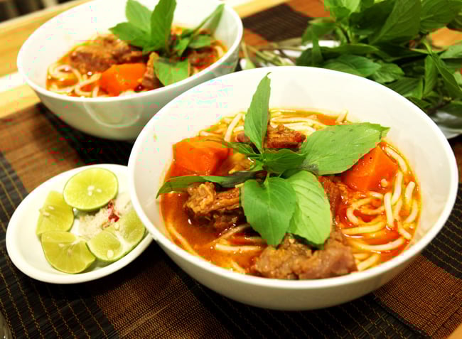 To fully appreciate Bún bò cay, dip the beef cubes into a zesty salt-chili-lime mix sourced from loc...