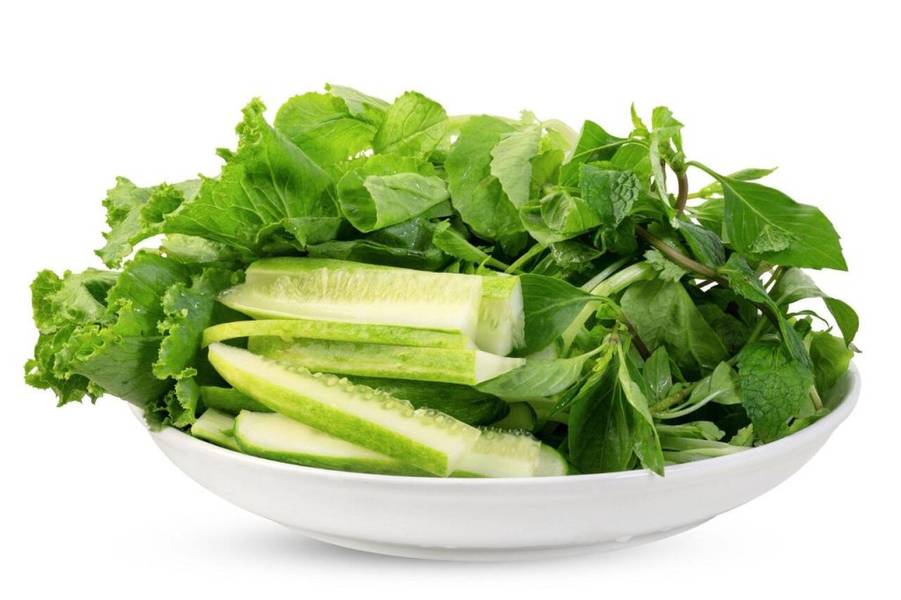 The accompaniments are rich and inviting: thinly sliced onions, shredded carrots, grated coconut for...