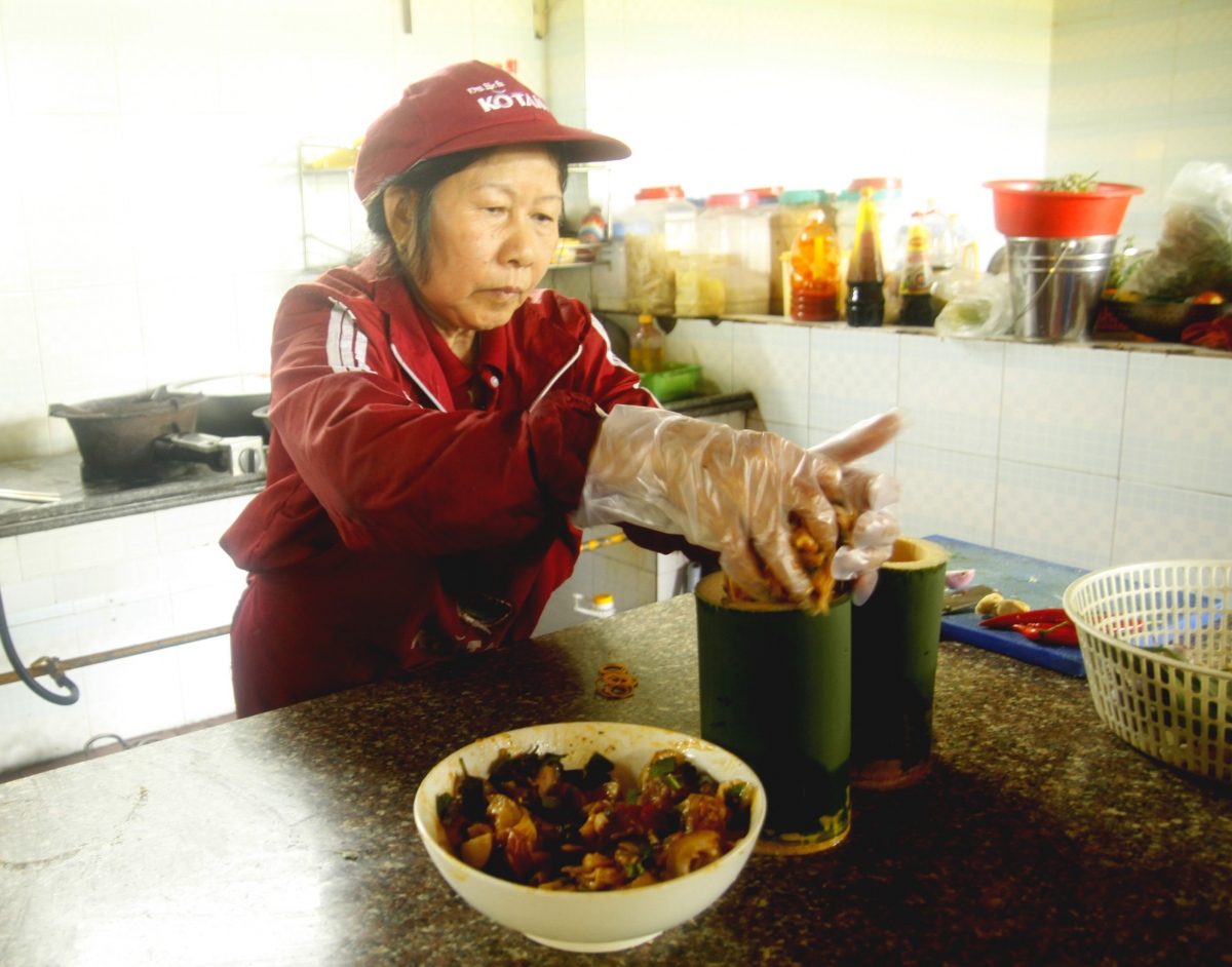 After marinating for about 15 minutes to let the flavors penetrate, the meat is packed into bamboo t...