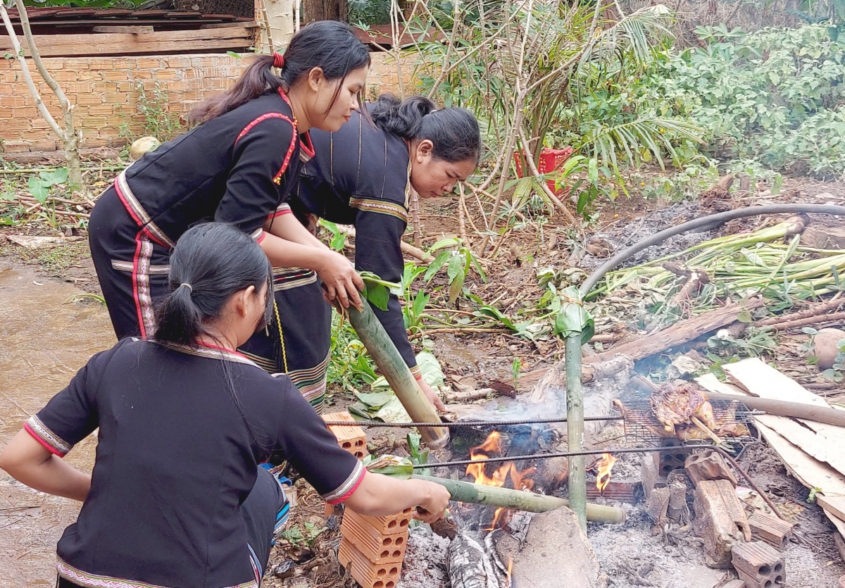 The bamboo tubes are grilled over glowing charcoal for about one hour. Cooks must rotate them consta...