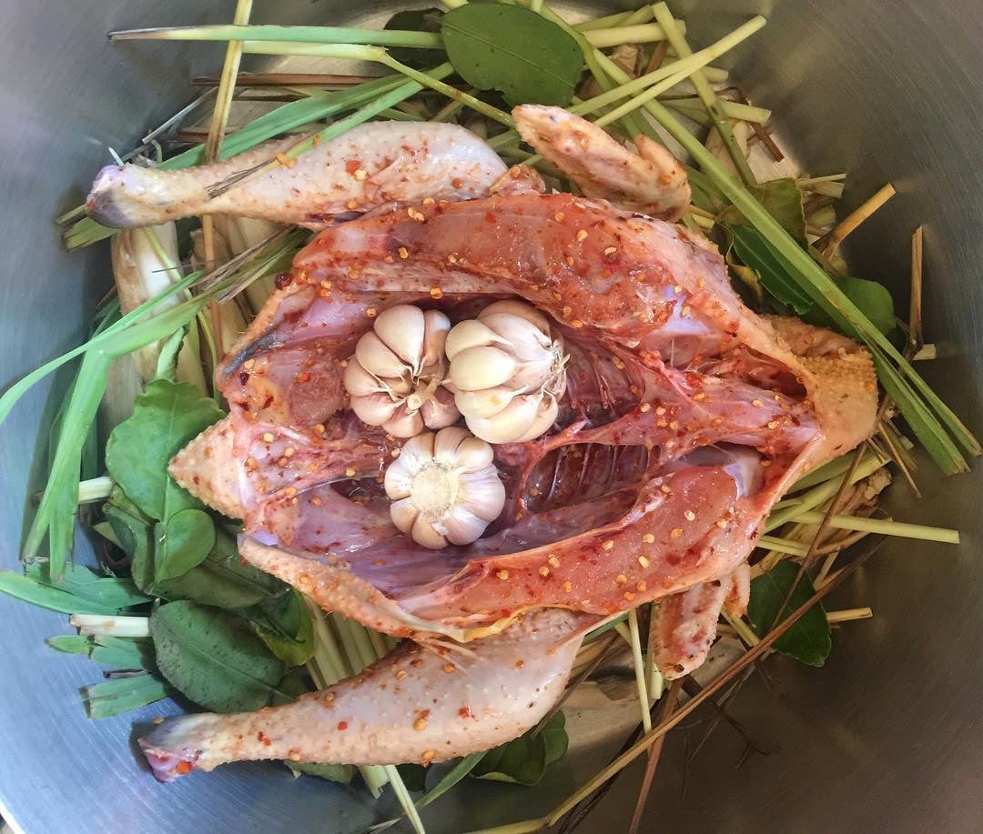 Preparation is an art: a thick bed of lemongrass and chúc leaves is laid down first, drizzled with o...