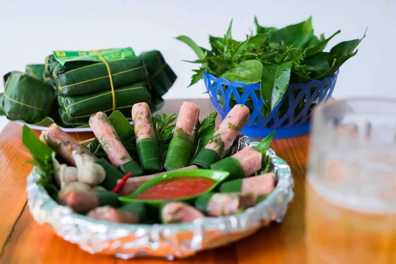 The best way to savor Nem Chua Thanh Hoa is with crisp fresh herbs and a dip of sweet-sour fish sauc...
