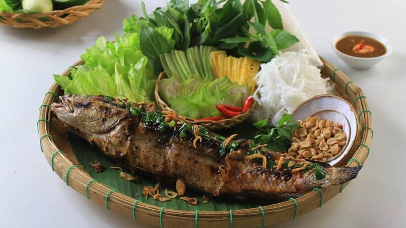 Ca Loc Nuong Trui (grilled snakehead fish) is a simple, rustic dish that nevertheless captivates hea...