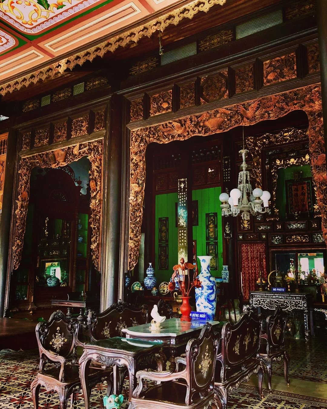 The interior of Binh Thuy Ancient House is a treasure trove of valuable antiques, symmetrically arra...