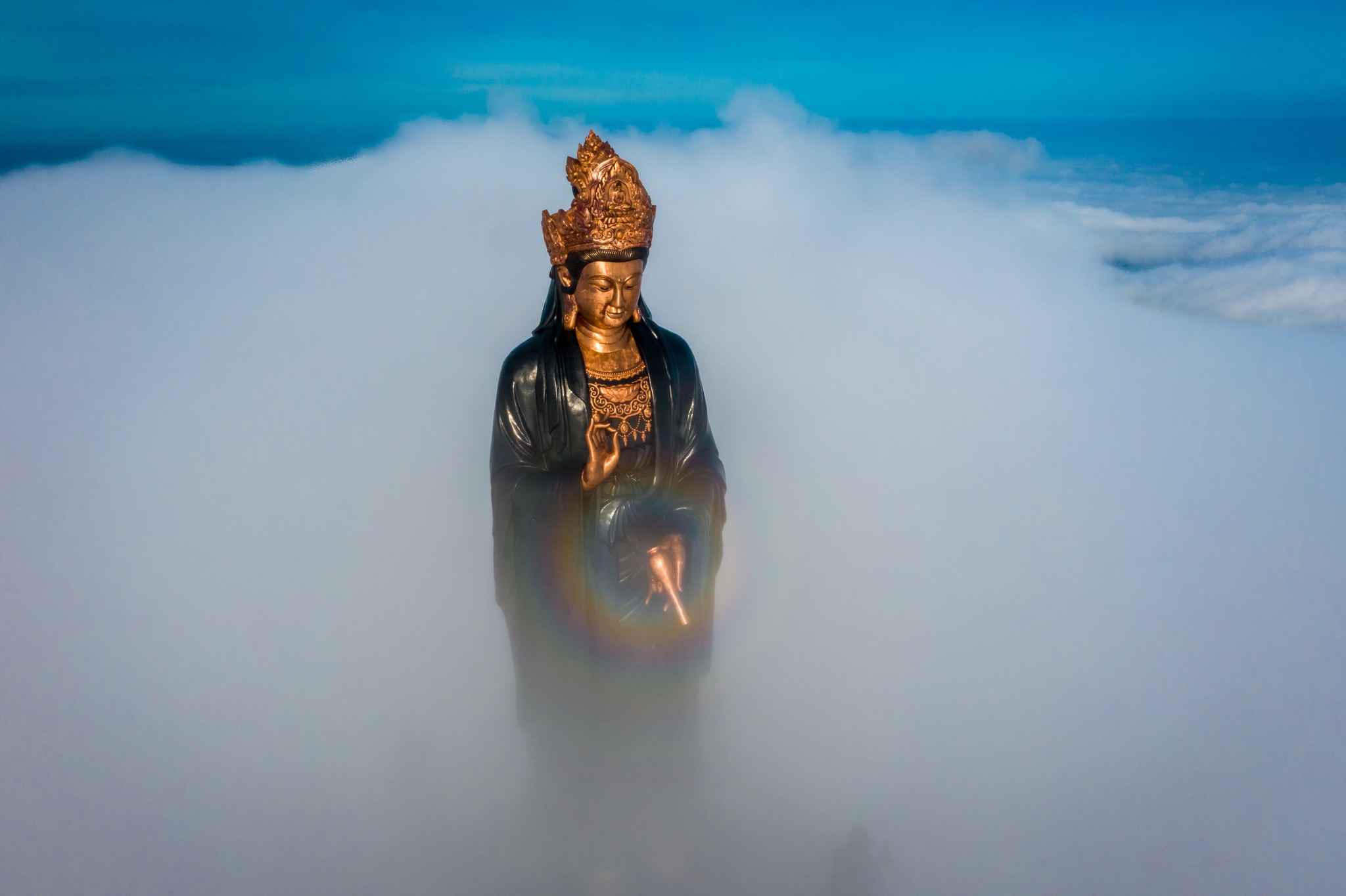 Prominently standing on the mountaintop is the Statue of Tây Bổ Đà Sơn Buddha, a magnificent spiritu...