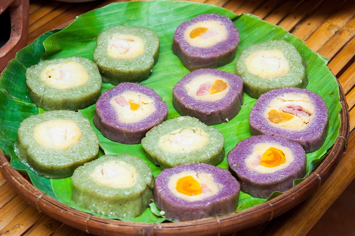 Bánh tét lá cẩm is more than a specialty; it is deeply tied to Southern Tet traditions of ancestral ...