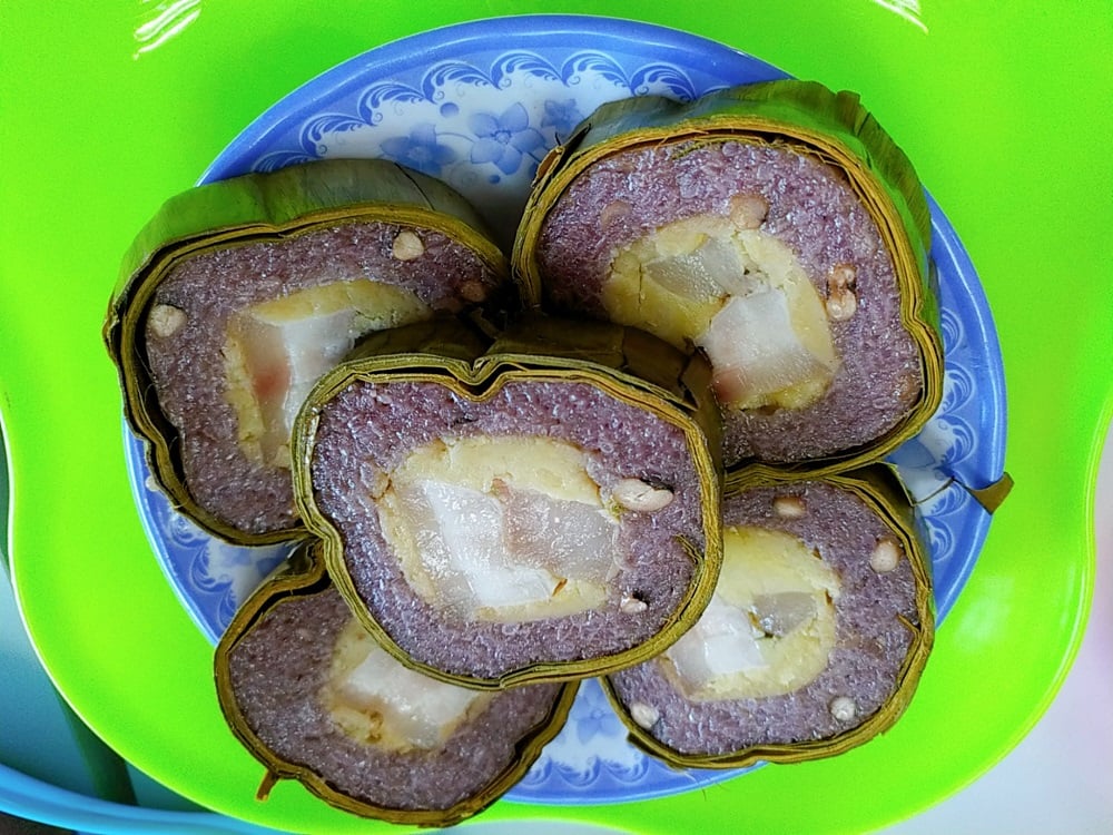 When sliced, the shiny purple rice reveals fragrant meat, creamy salted egg yolk, and sweet mung bea...